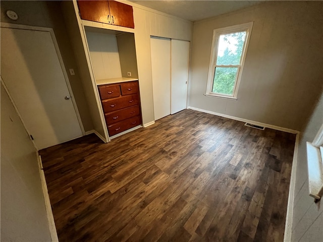 unfurnished bedroom featuring dark hardwood / wood-style floors