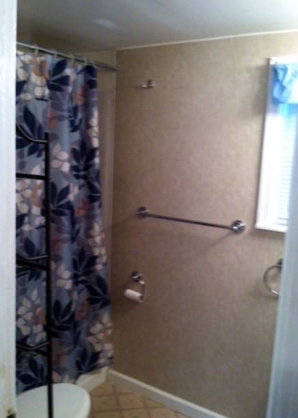 bathroom featuring toilet and walk in shower