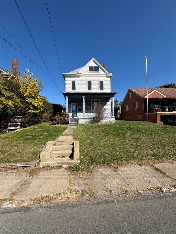 view of front of home featuring covered porch and a front lawn