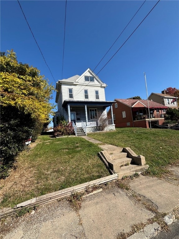 view of front facade with a front yard and a porch