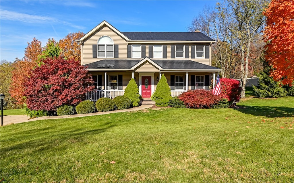 view of front of house with a front yard and covered porch