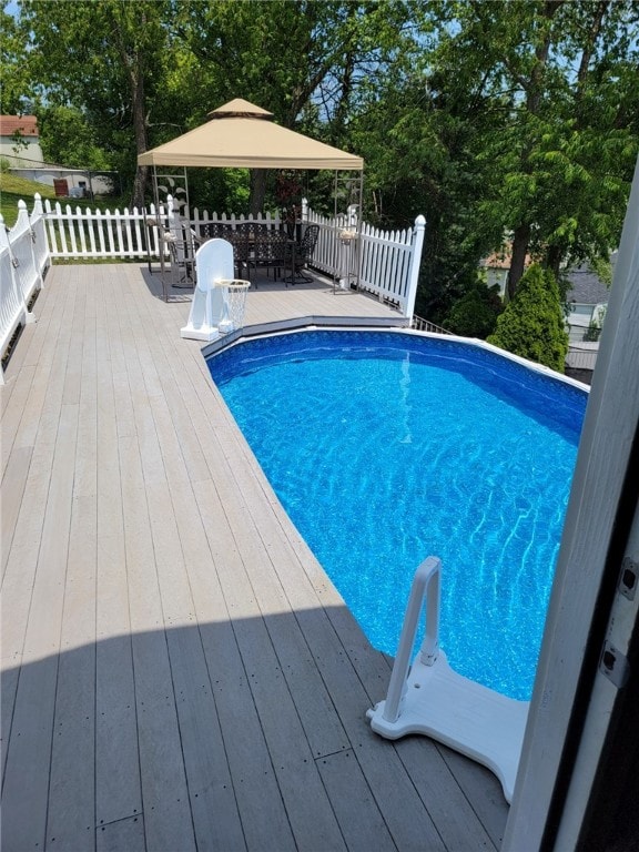 view of swimming pool featuring a wooden deck