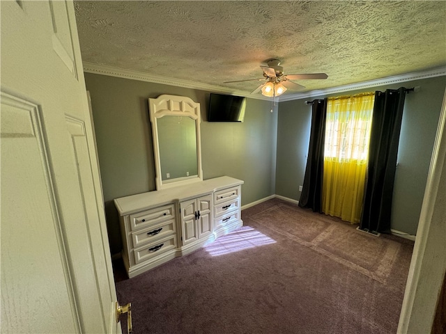 unfurnished bedroom featuring dark carpet, crown molding, a textured ceiling, and ceiling fan