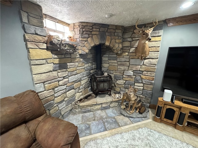 living room featuring a textured ceiling and a wood stove