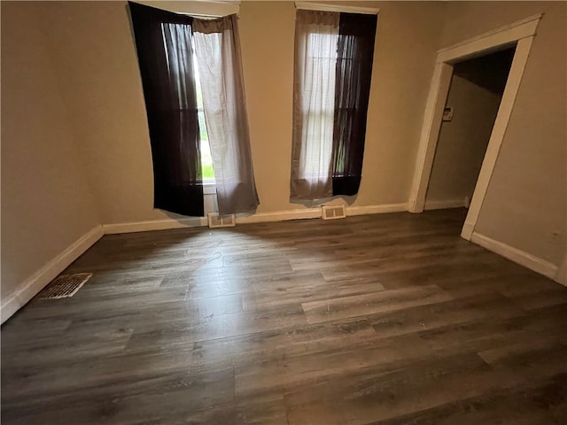 spare room featuring dark hardwood / wood-style flooring