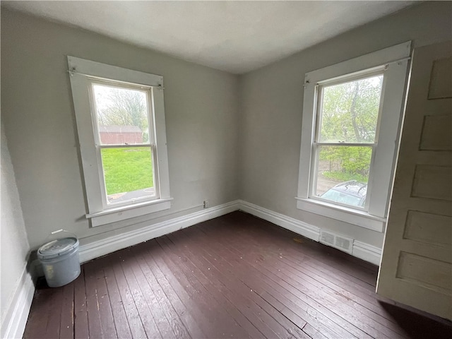 empty room featuring dark wood-type flooring