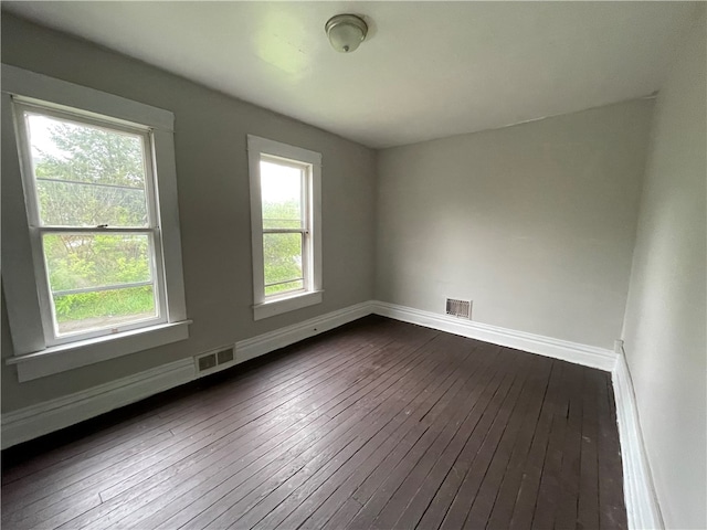 empty room featuring hardwood / wood-style flooring and a wealth of natural light