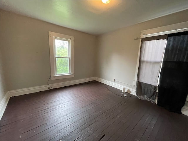 unfurnished room with dark hardwood / wood-style floors