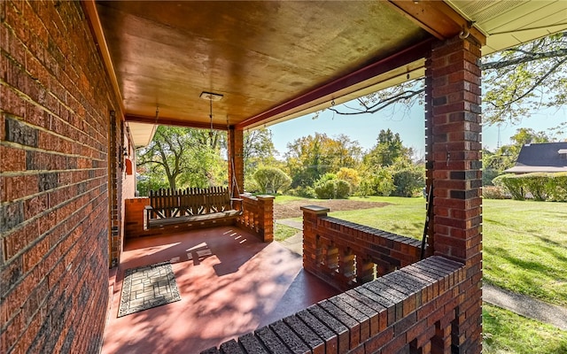 deck featuring covered porch and a yard