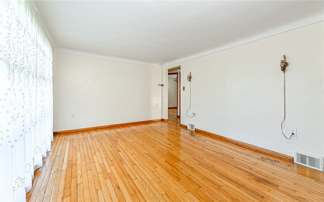 spare room featuring light wood-type flooring