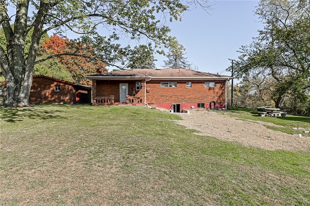 back of property featuring a lawn