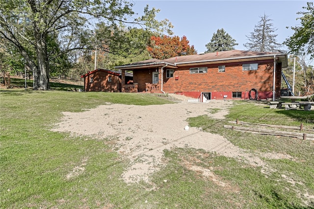 rear view of property featuring a yard