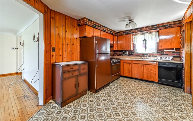 kitchen with dishwasher, fridge, wooden walls, decorative backsplash, and range with gas stovetop