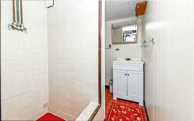 bathroom featuring vanity and tiled shower