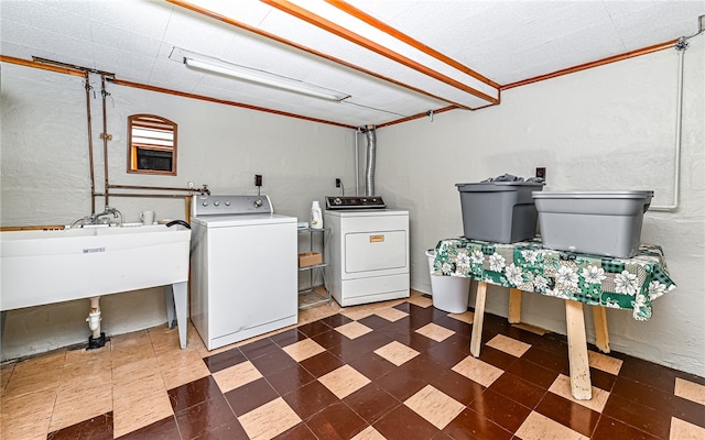 clothes washing area featuring independent washer and dryer, sink, and crown molding