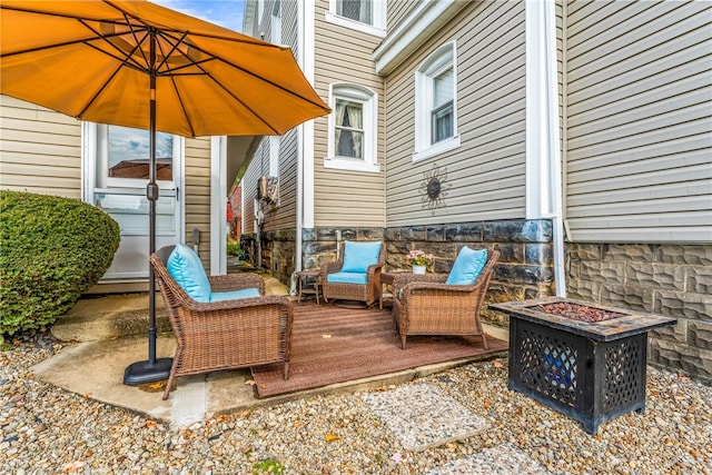 view of patio / terrace with an outdoor living space with a fire pit