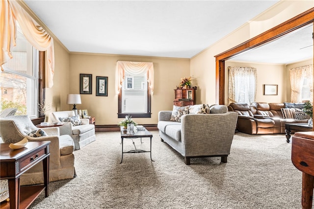 carpeted living room with crown molding and a healthy amount of sunlight