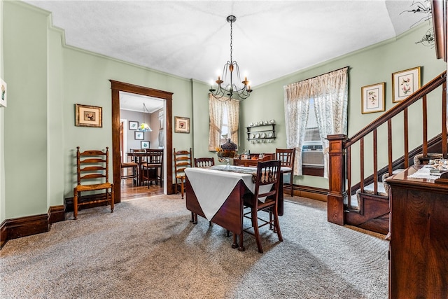 carpeted dining space with cooling unit, an inviting chandelier, and ornamental molding