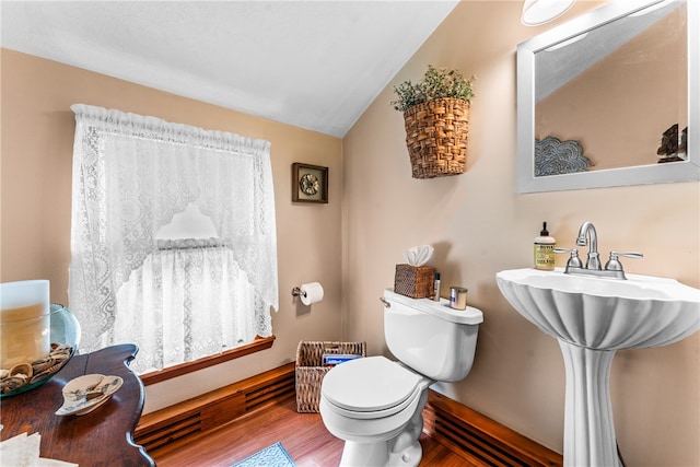 bathroom featuring lofted ceiling, wood-type flooring, and toilet