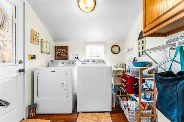 laundry room featuring cabinets, dark hardwood / wood-style floors, and washing machine and clothes dryer