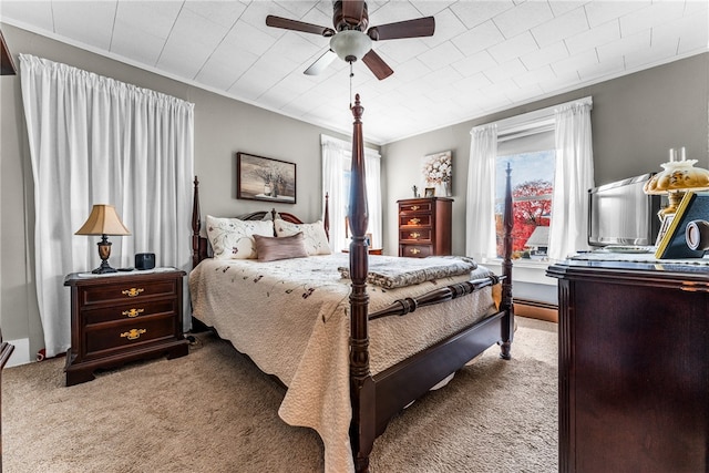 bedroom with ceiling fan, crown molding, multiple windows, and light colored carpet