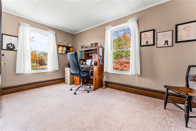 carpeted home office featuring baseboard heating, ornamental molding, and wood walls