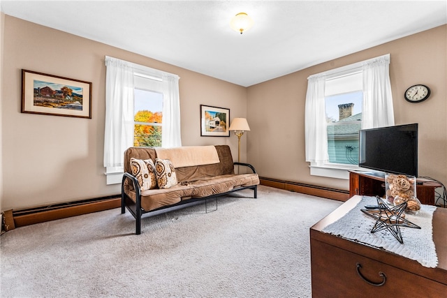 carpeted living room featuring a baseboard heating unit