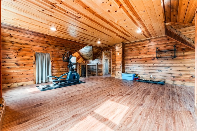 exercise room with wood walls, vaulted ceiling, wood-type flooring, and wooden ceiling