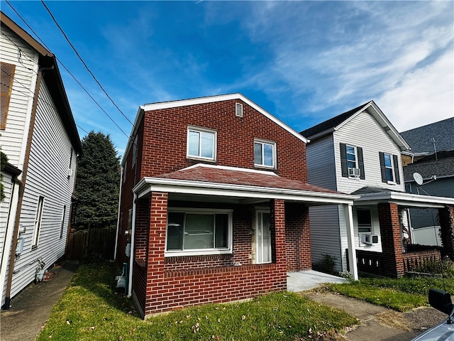 view of front facade with a porch, cooling unit, and a front lawn