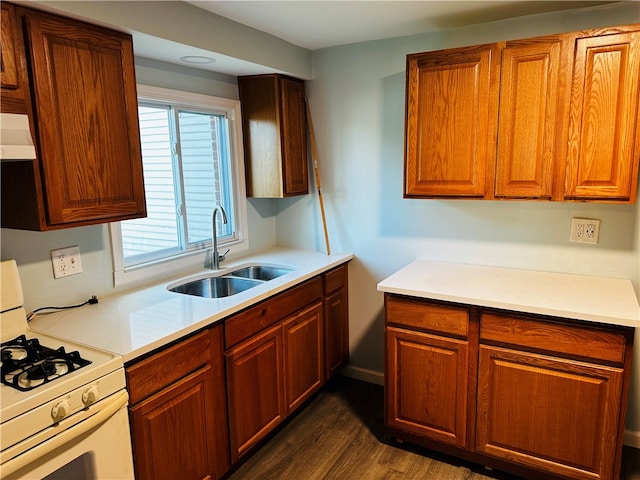 kitchen with sink, ventilation hood, white range with gas cooktop, and dark hardwood / wood-style floors