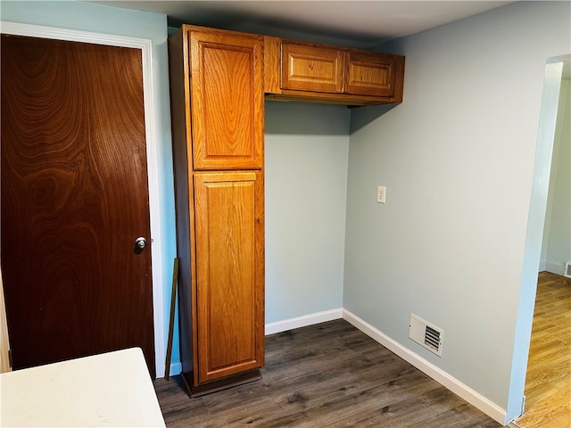 laundry area featuring dark hardwood / wood-style flooring