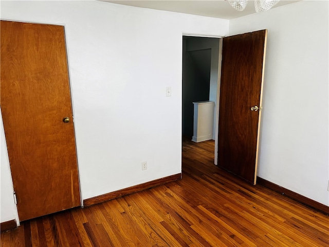 unfurnished room featuring dark hardwood / wood-style floors