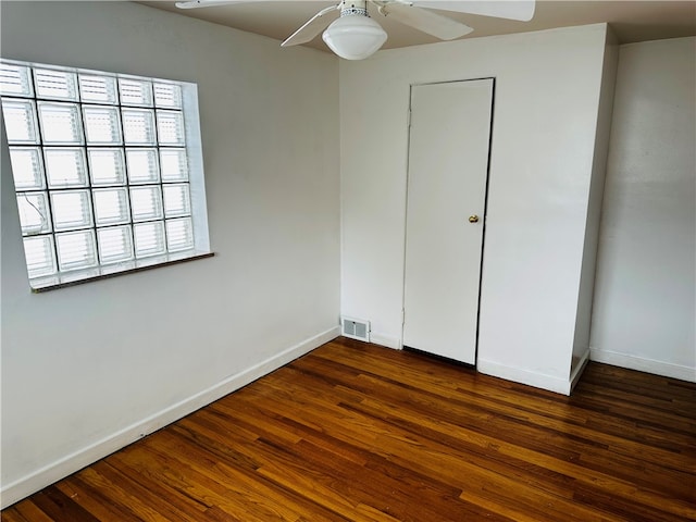 unfurnished bedroom with a closet, ceiling fan, and dark hardwood / wood-style flooring