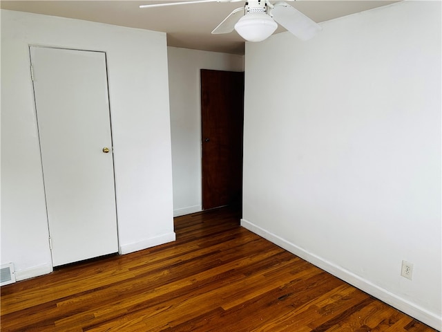 unfurnished bedroom with dark hardwood / wood-style floors and ceiling fan