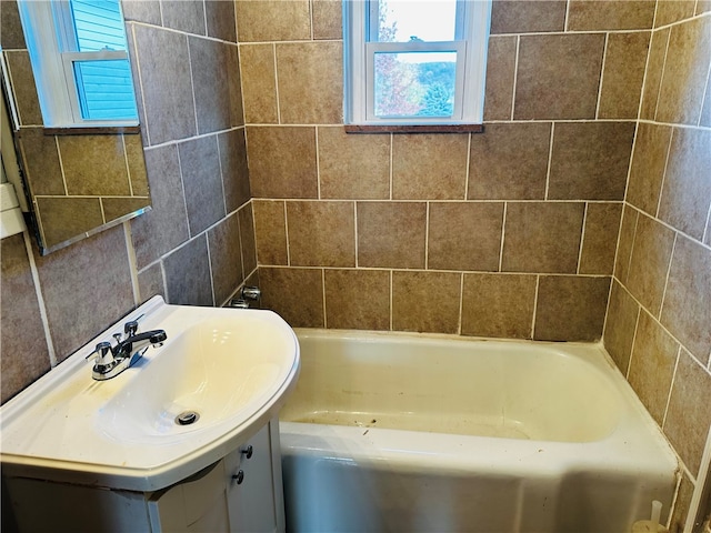 bathroom with vanity and a tub