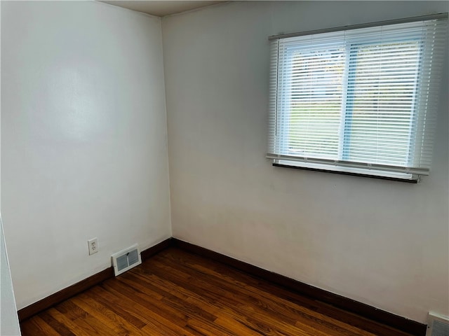 empty room with dark wood-type flooring