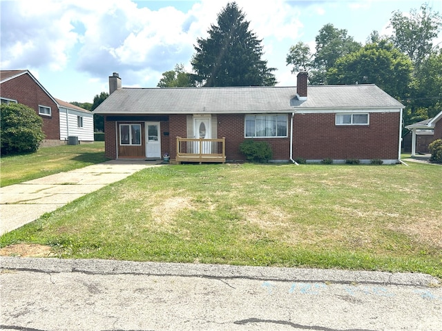 ranch-style house featuring central air condition unit and a front lawn