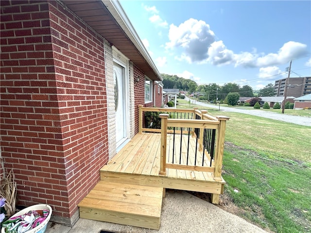 wooden deck with a lawn