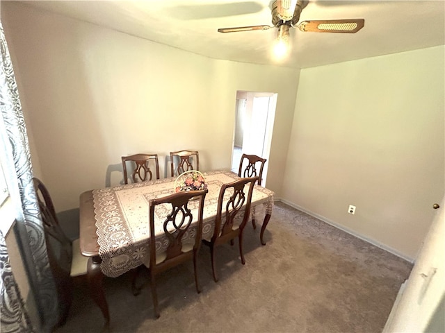 carpeted dining area featuring ceiling fan