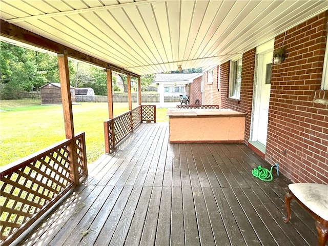 wooden deck featuring a yard