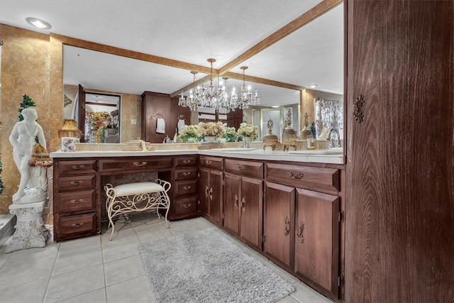 bathroom with vanity, beam ceiling, a notable chandelier, and tile patterned flooring