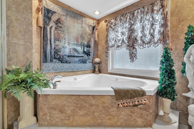 bathroom featuring tile walls, tiled bath, and tile patterned floors