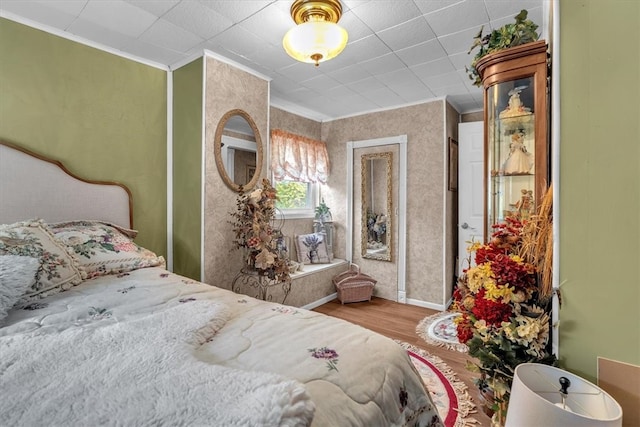 bedroom featuring crown molding and hardwood / wood-style flooring