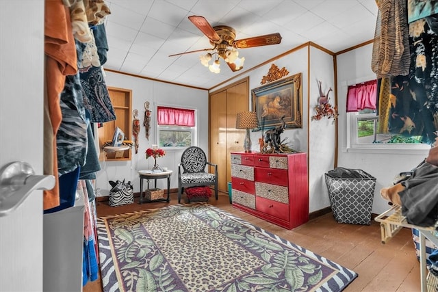 bedroom featuring ornamental molding, hardwood / wood-style floors, and ceiling fan