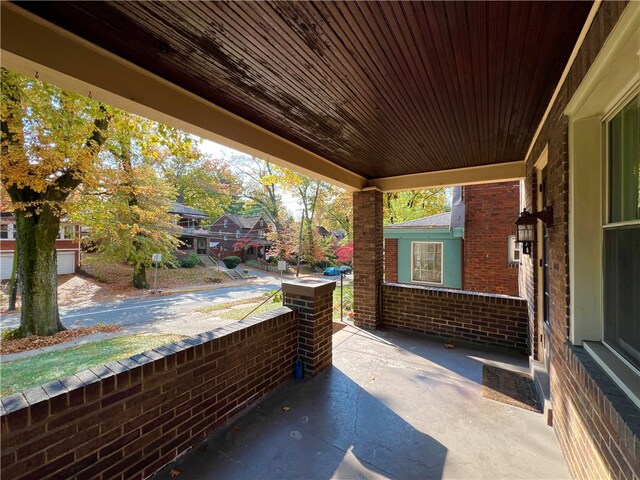 view of patio featuring a porch and a garage