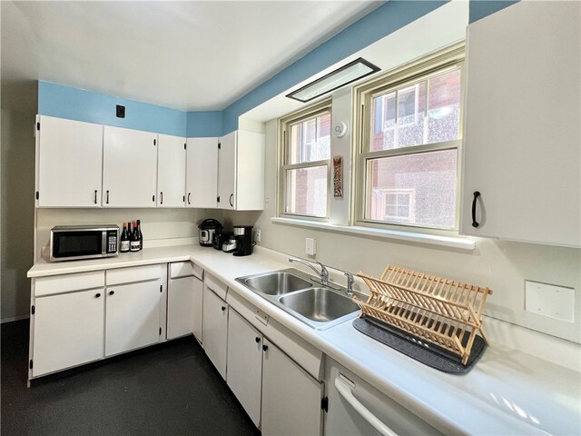 kitchen with white cabinetry and sink