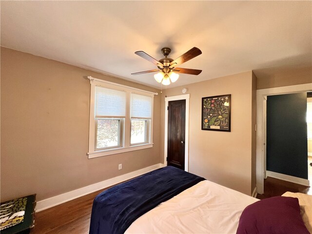 bedroom with dark hardwood / wood-style floors and ceiling fan