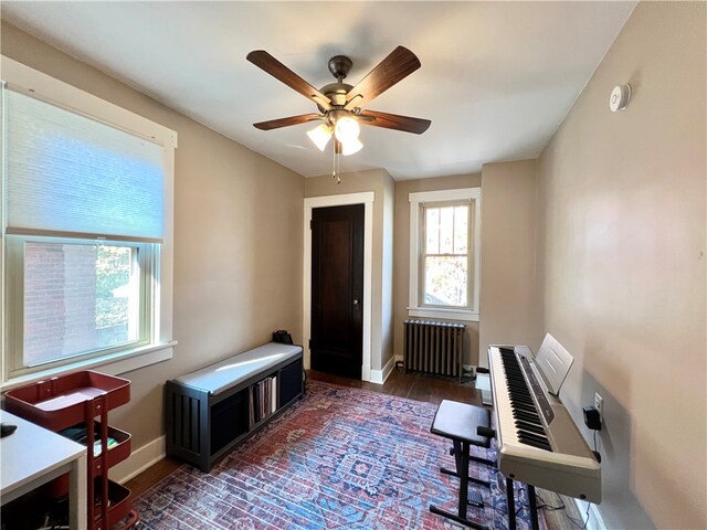 miscellaneous room featuring radiator heating unit, dark hardwood / wood-style floors, and ceiling fan