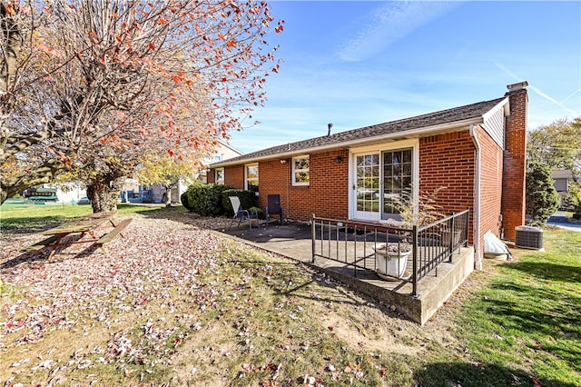 back of house featuring a patio, central air condition unit, and a lawn