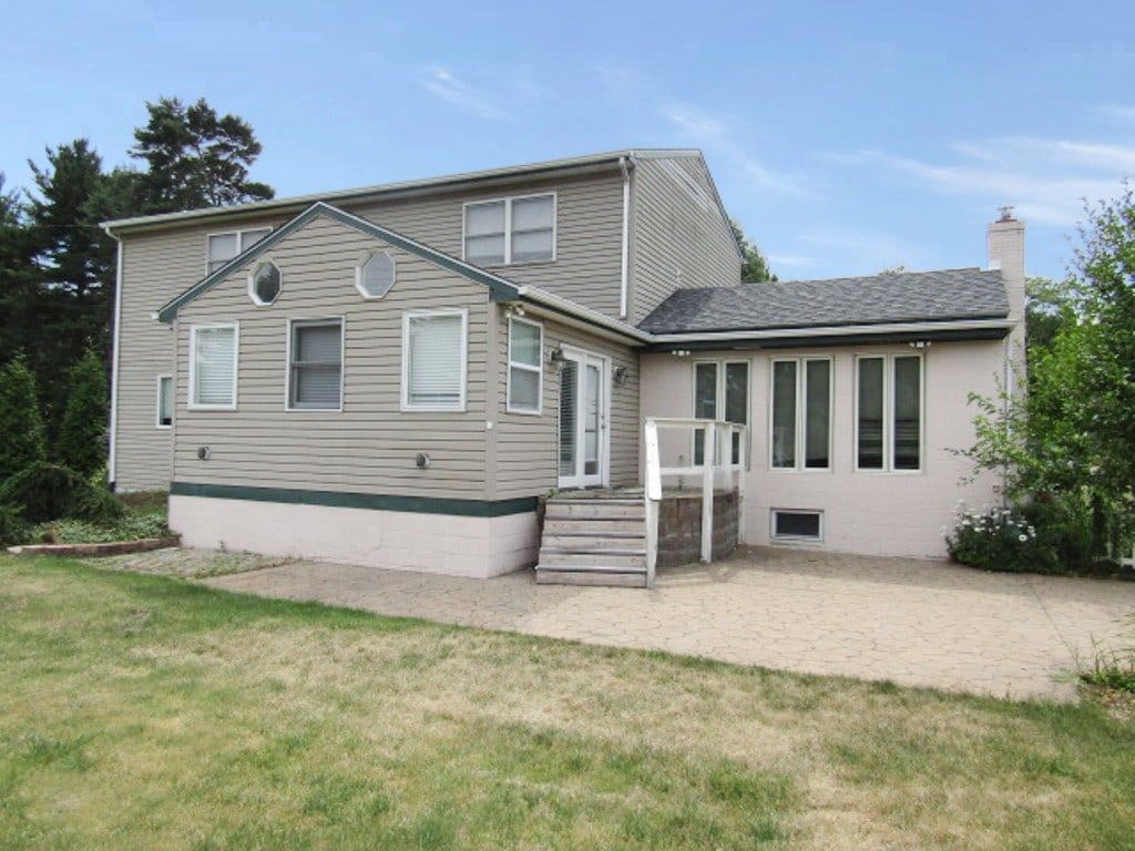 rear view of property with a patio area and a lawn